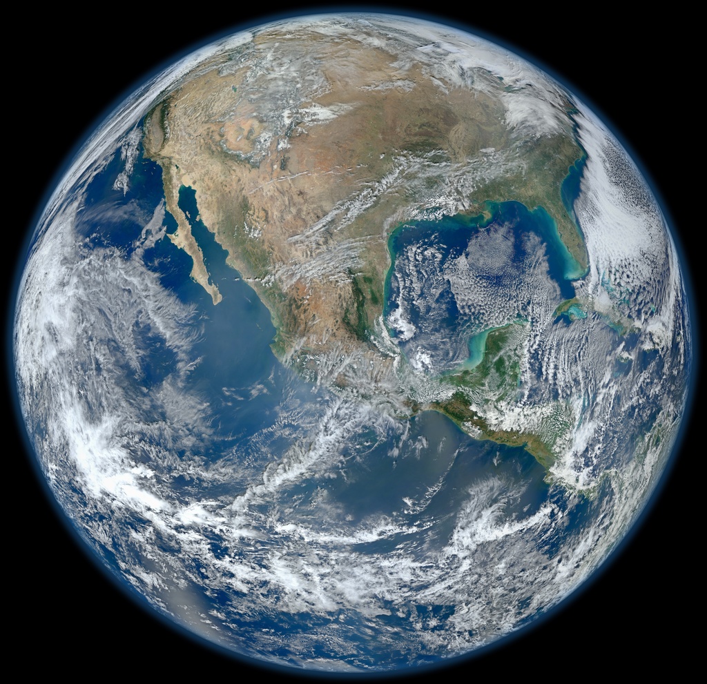 NASA satellite composite of Earth, with bright clouds swirling over blue oceans